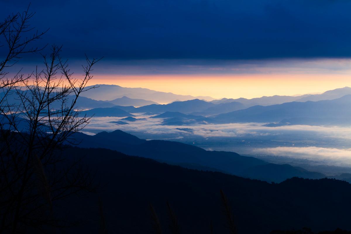 Witnessing the world wake up, layer by layer. The embrace of dawn over the tranquil mountains.